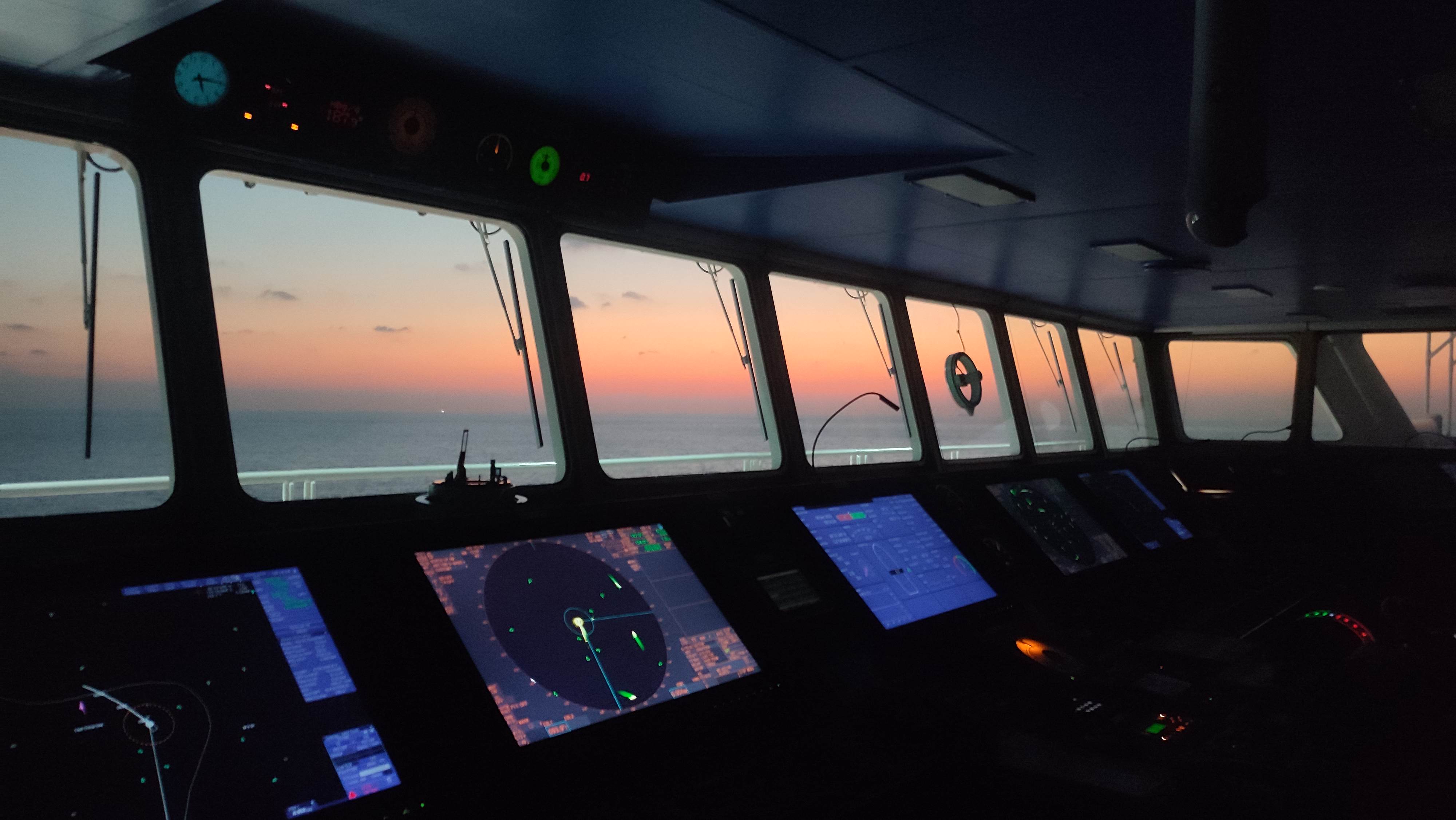Ship bridge at sunset with navigation instruments